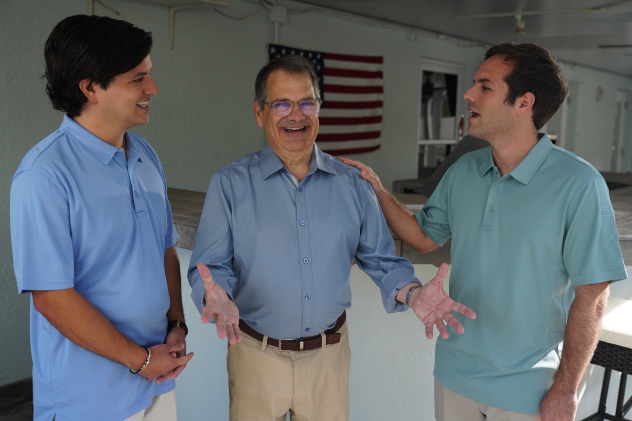 Gus with supporters in front of an American flag